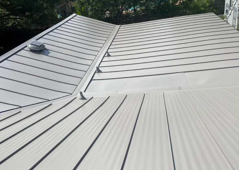 Solar attic fan installed on a metal roof for Roof Ventilation in Golden